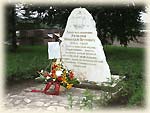 Laying flowers at the monument at the first bury place of Rezanov